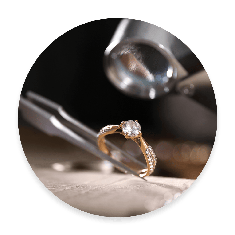 Jewelry Pliers Holding a Gold Diamond Ring